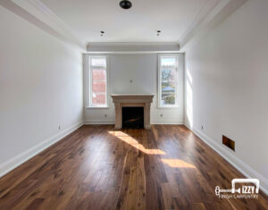 Studio with wooden floors, baseboards and wooden windows