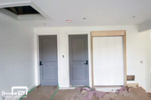 Work in progress with wooden doors, frames, and baseboards