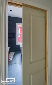 Bathroom wooden sliding door and window in the back