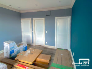 Room with wooden floors, baseboards, and doors