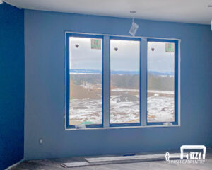 Room with our wooden work in progress on the windows, baseboards, and floors