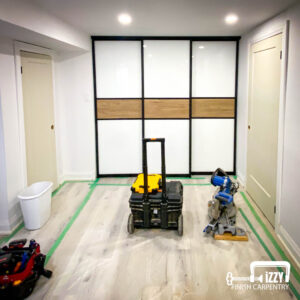 Sliding doors with wood finishes, wood doors in progress, wooden floors, and baseboards