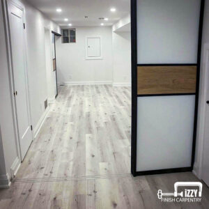 Sliding doors with wood finishes, a normal door in progress, wooden floors, and baseboards