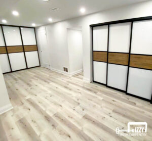 Sliding doors with wood finishes, a normal door in progress, wooden floors, and baseboards