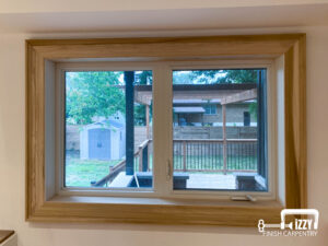 Window with wooden frame with a deck behind them