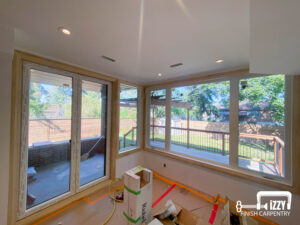 Windows and glass door with wooden frames, a wooden deck behind